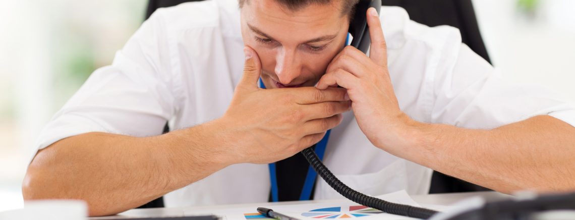 office worker making a private call with a company phone