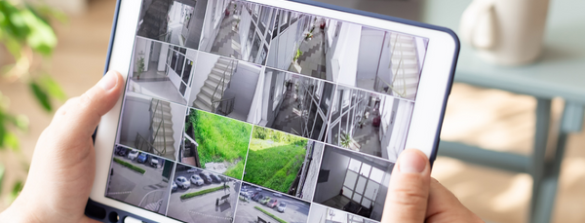Employer looking at workplace CCTV on iPad