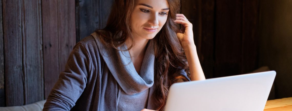 Portrait of a beautiful young woman working with a laptop